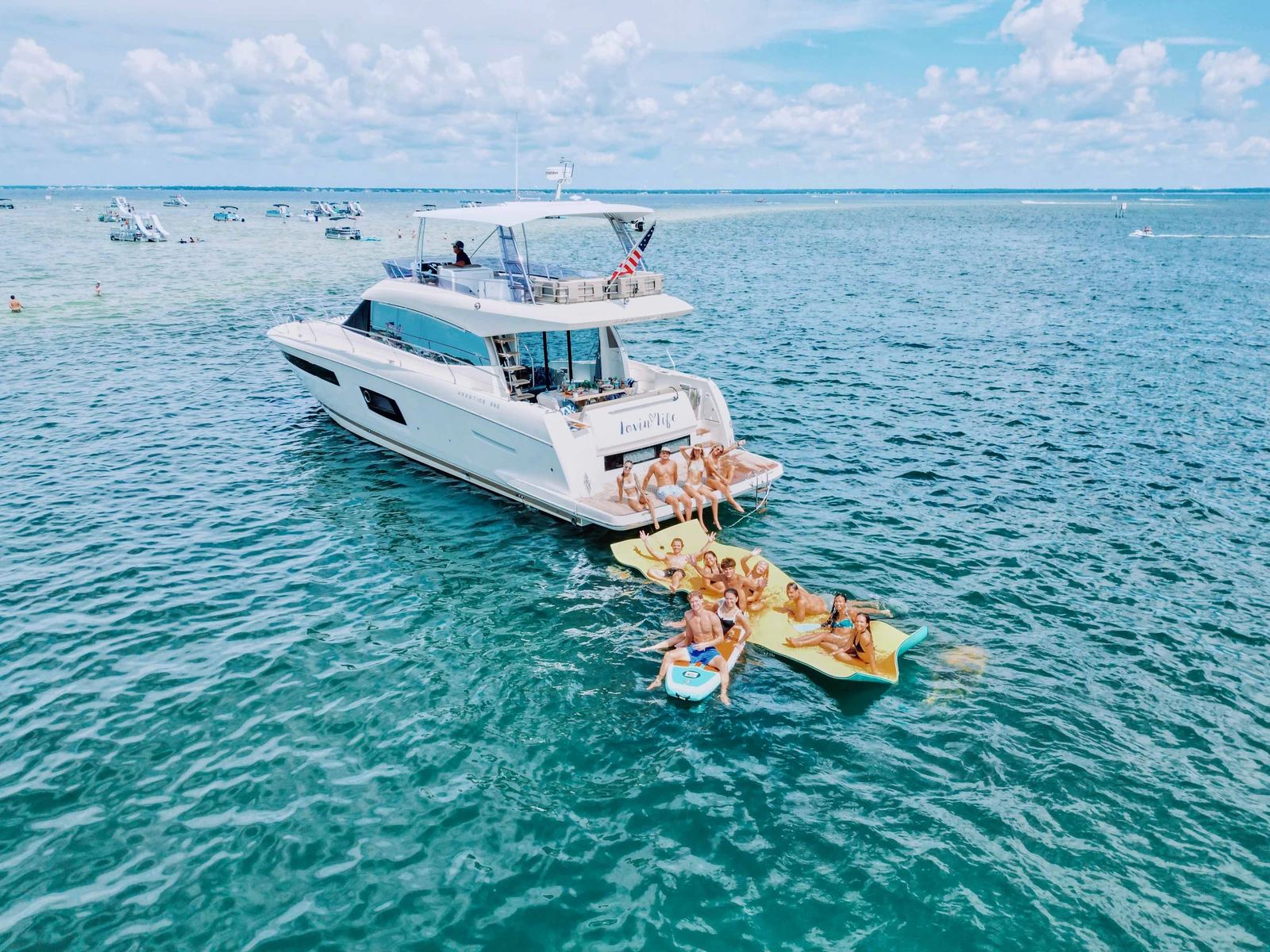 Boats gathered in the shallow emerald water at Crab Island near Destin, Florida
