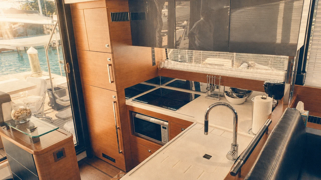 Full galley kitchen with cooktop, oven, and sink aboard a Prestige 550 Destin yacht charter