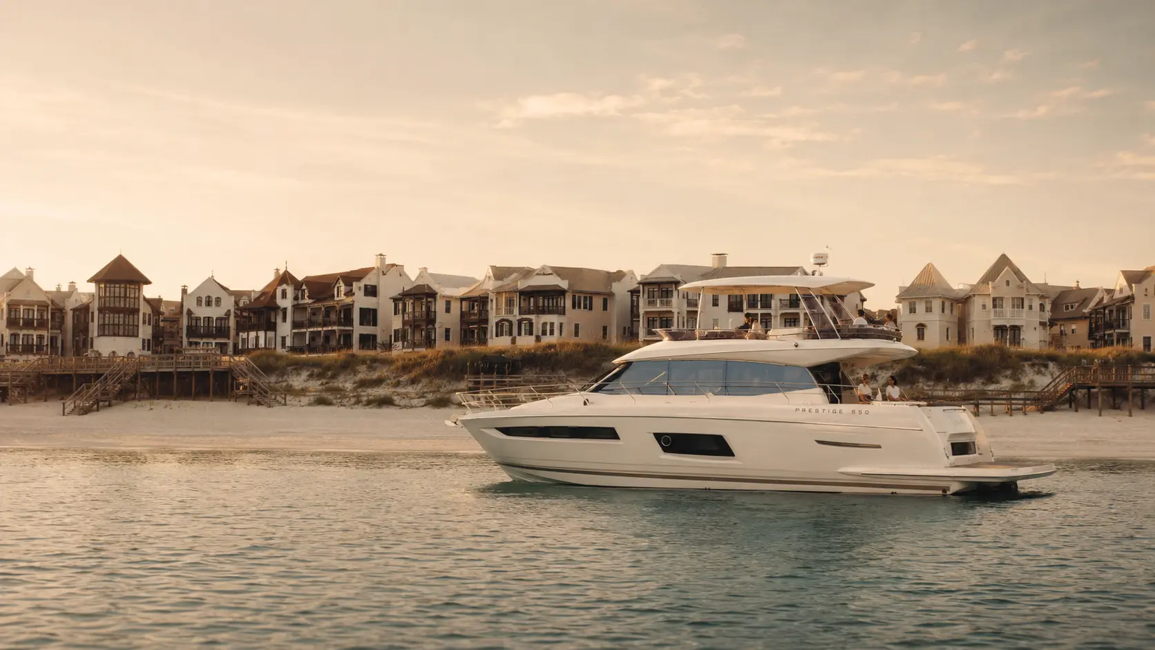 The Lovin' Life yacht anchored off Rosemary Beach, Florida, with the town's coastal architecture at sunset