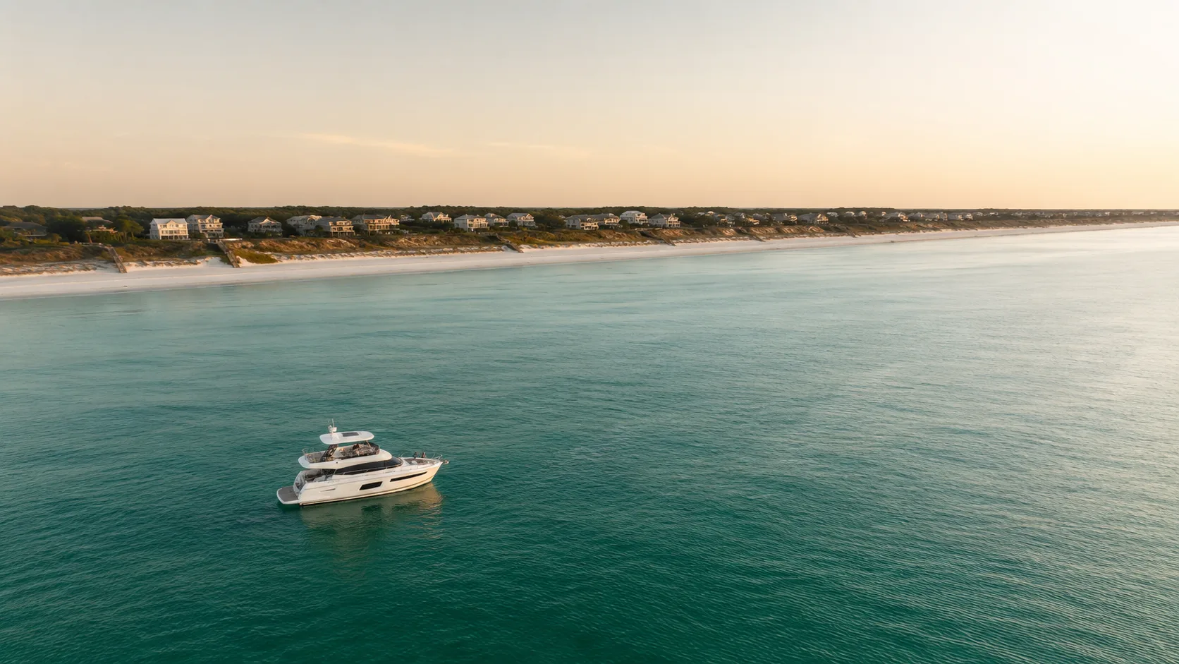 Aerial view of a private yacht charter anchored along the Santa Rosa Beach, Florida coastline