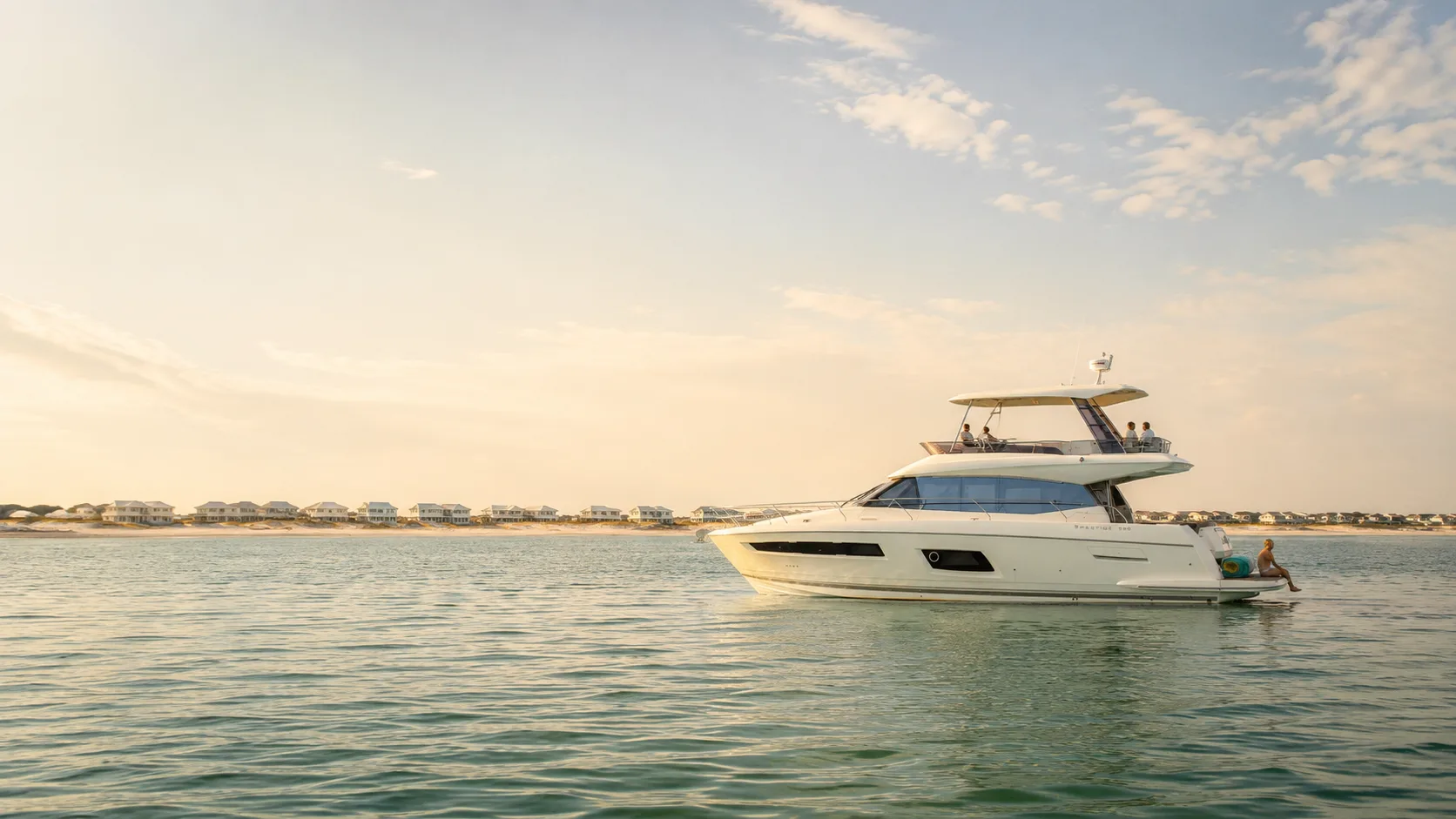 A private yacht charter anchored off Seaside, Florida, with a guest swimming nearby